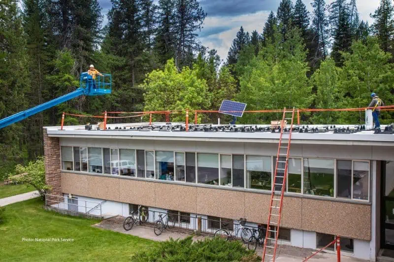 nonprofit solar being installed with crane onto building roof