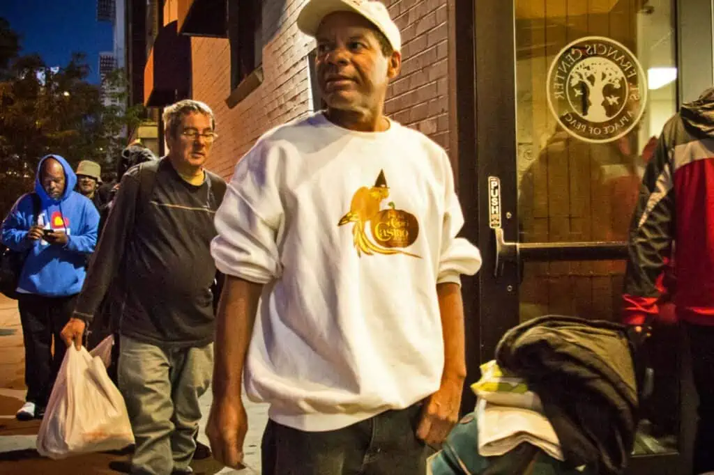 men standing outside waiting to go in St Francis Center
