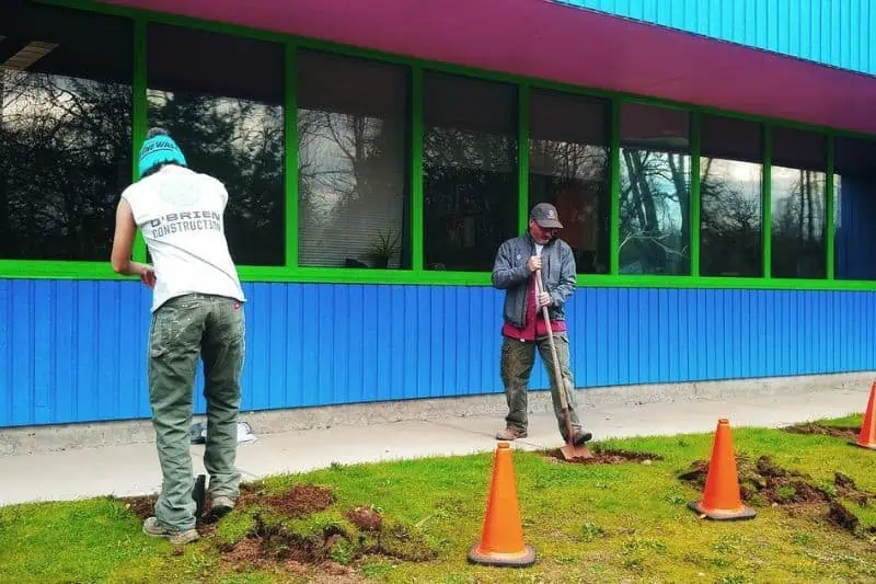two men working outside to install solar