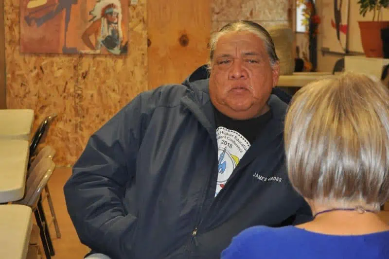 man and a woman sitting at a table talking