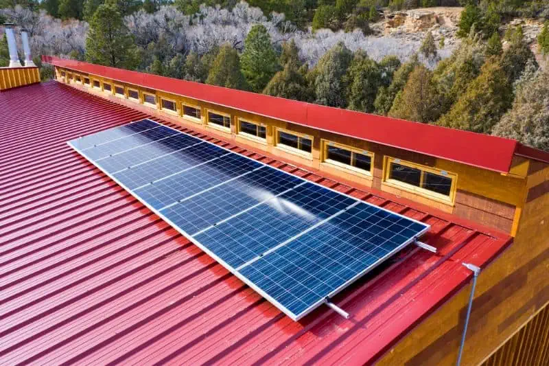 solar panels on a red metal roof