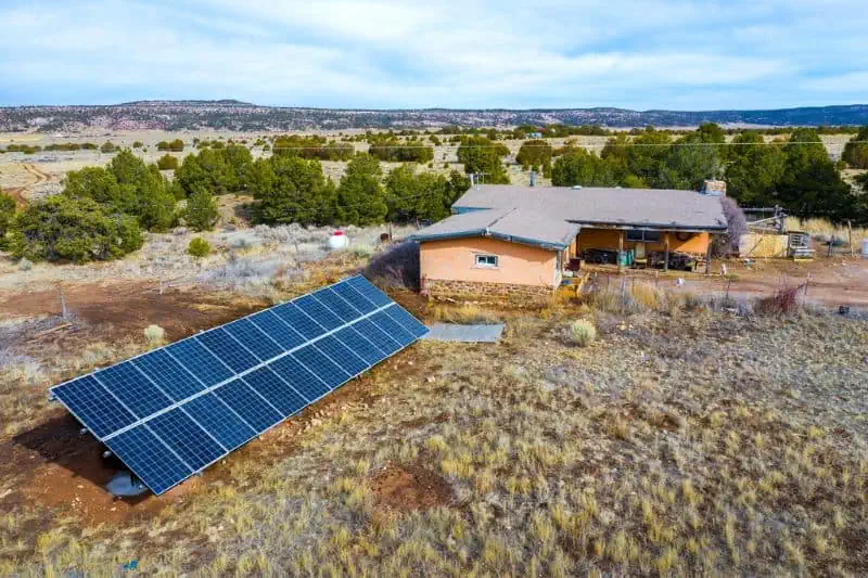 solar panels outside of a house in the desert