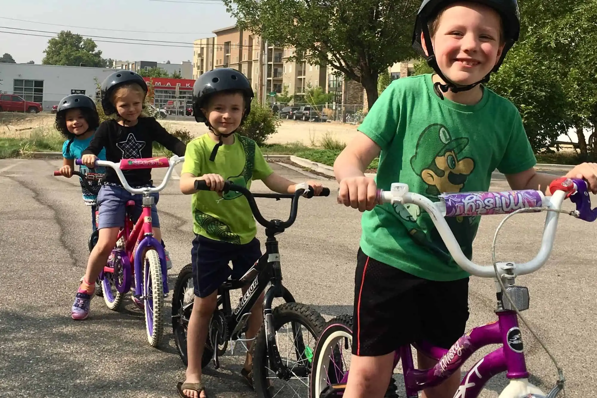 four kids riding bikes
