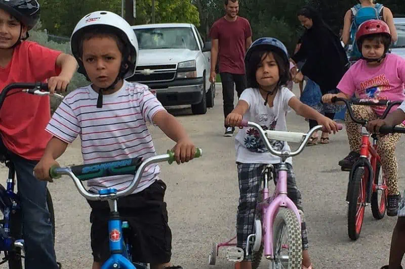 group of kids riding bikes in the street