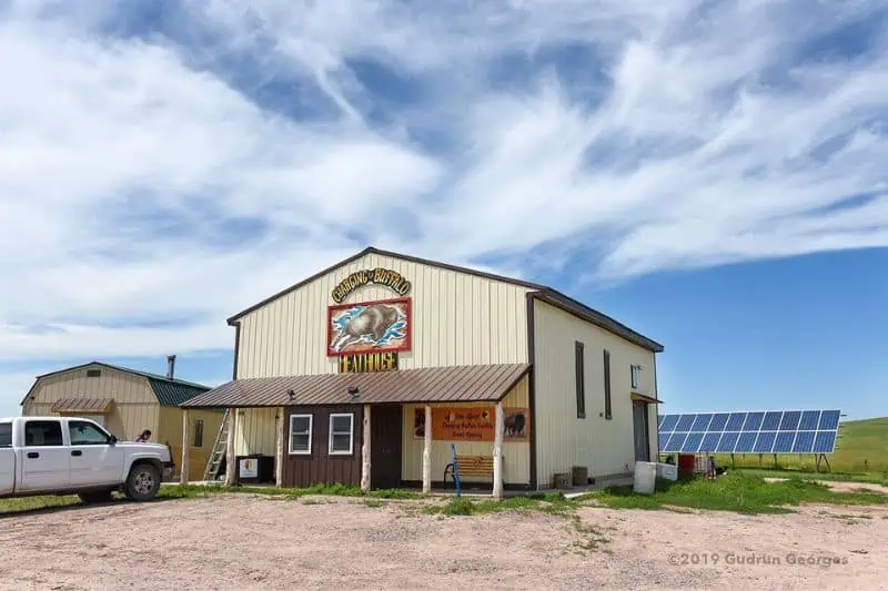 a meat house with solar panels in the back