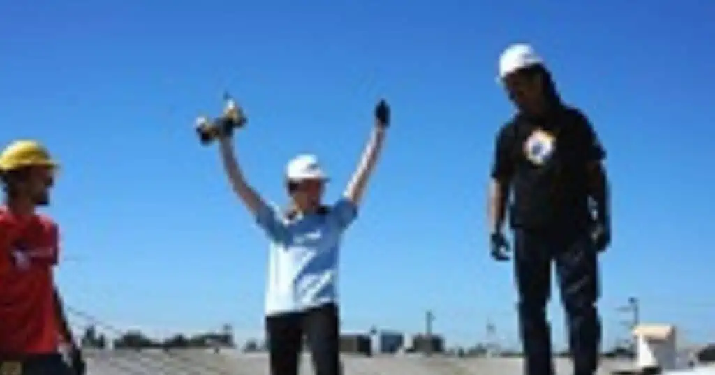 3 men installing solar on a roof