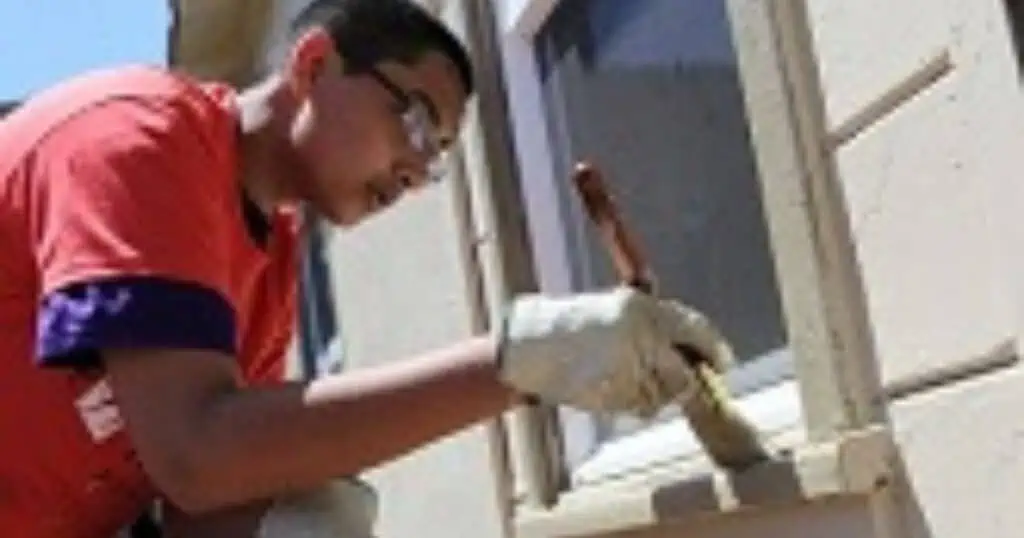 man painting a windowsill