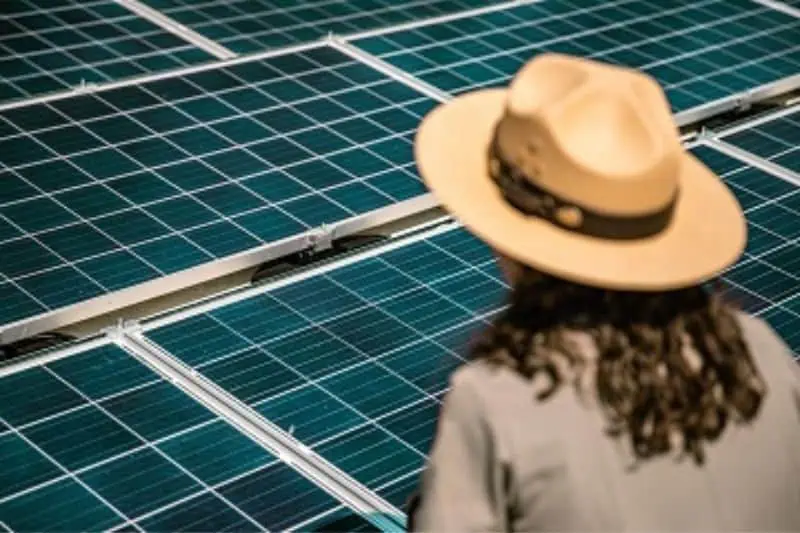 woman looking at installed solar panels