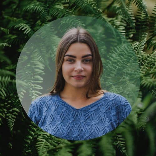 Sasha Aldobayeva headshot with green leaf background