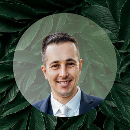 Youness Scally headshot with green leaf background