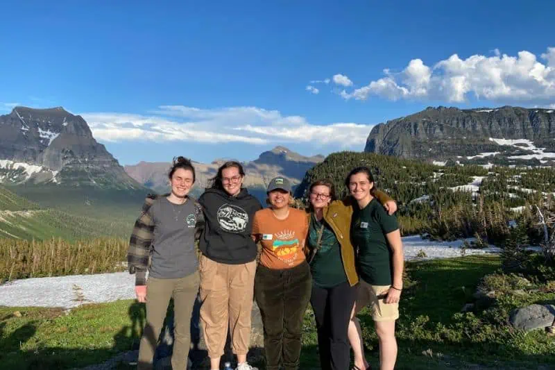 5 women standing in front of glacier mountain