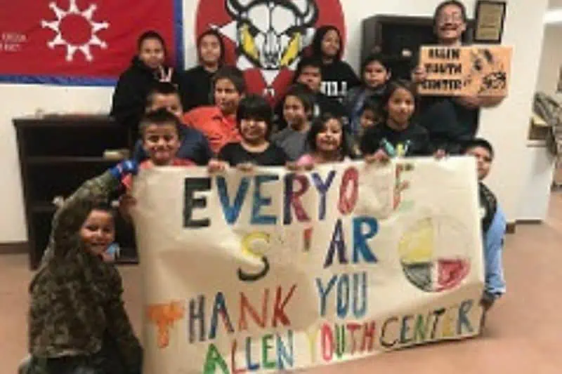kids holding up a thank you sign