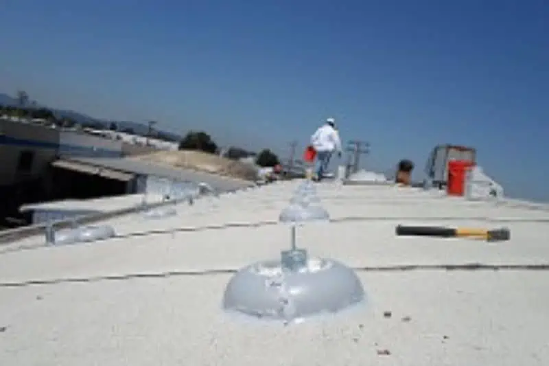 man walking along a roof