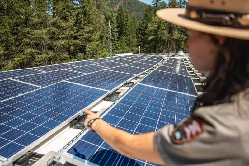 glacier national park ranger looking at solar panels