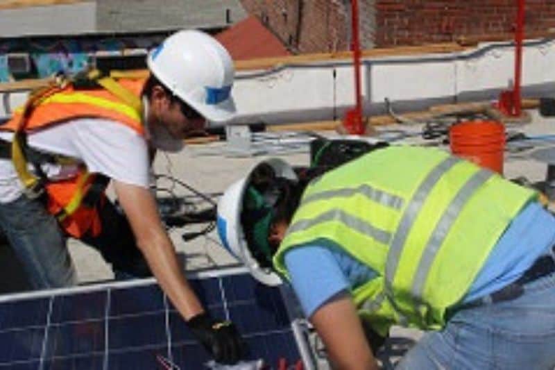 two former gang members install solar to a safe house