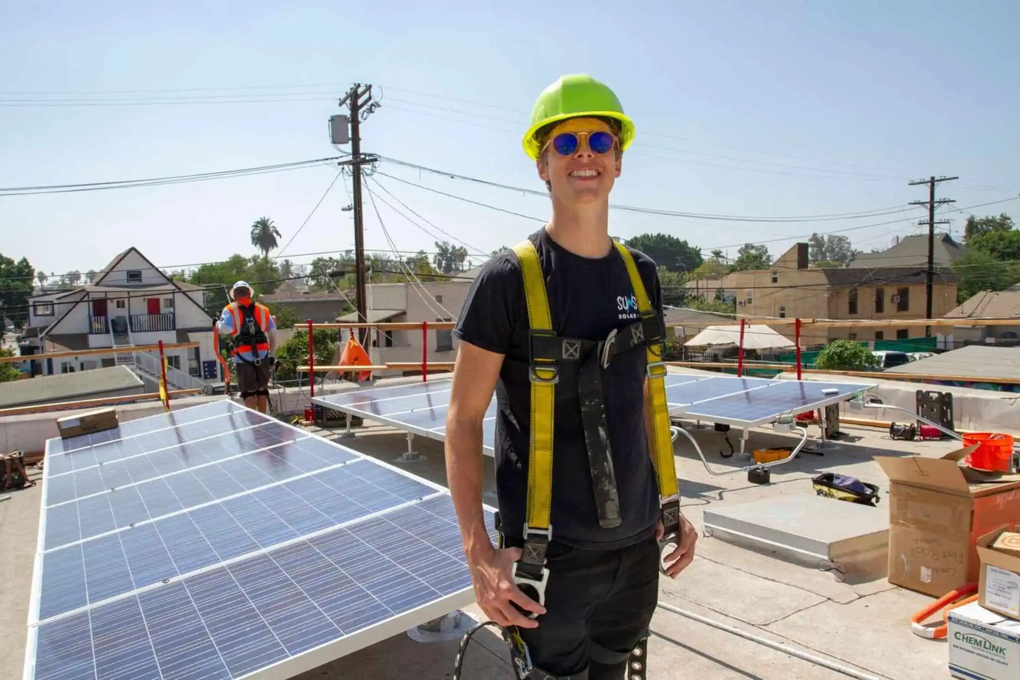 homeboy industries worker standing in front of newly installed solar panels