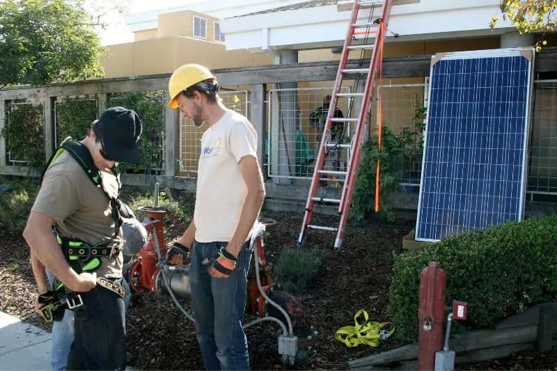 man working in the yard where solar is being installed