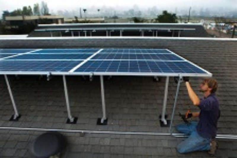 man setting up solar on the roof