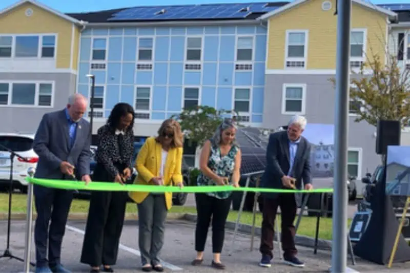 ribbon cutting ceremony at apartments after solar installed