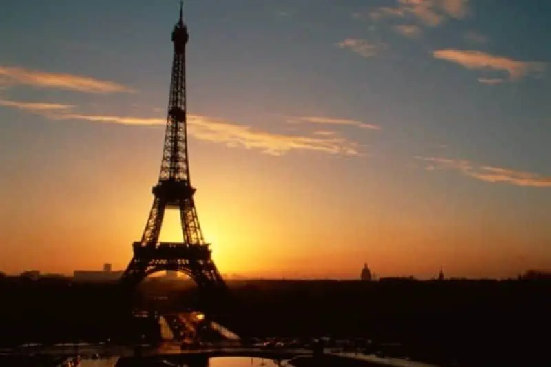 eiffel tower in paris with the sun behind it