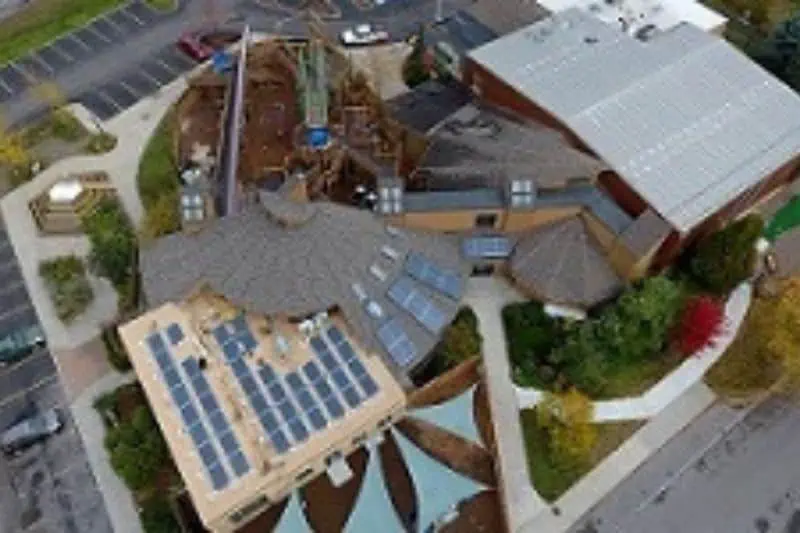ariel of a larg building with solar panels on the roof