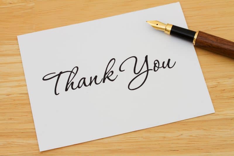 Thank you note with a ballpoint pen next on top of it
