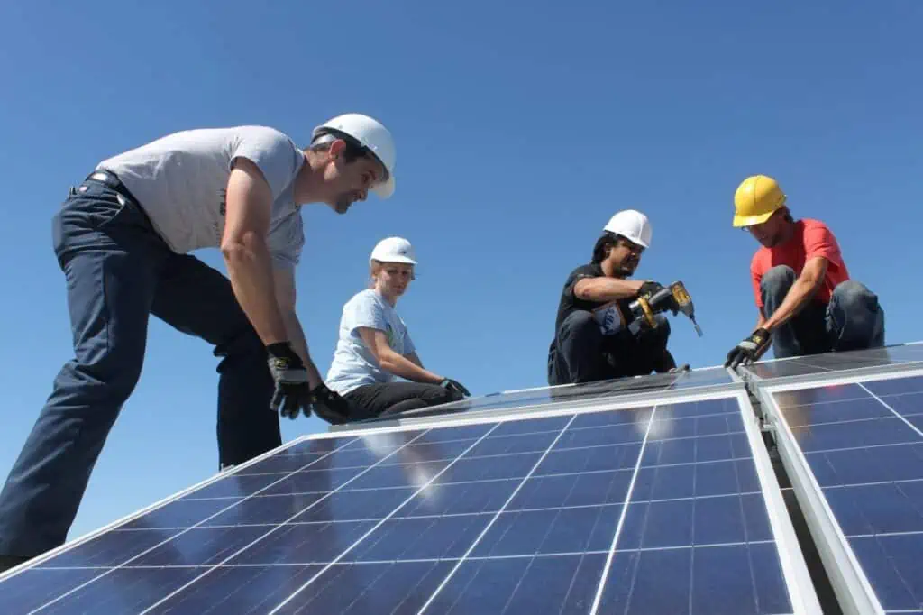 volunteers installing solar panels