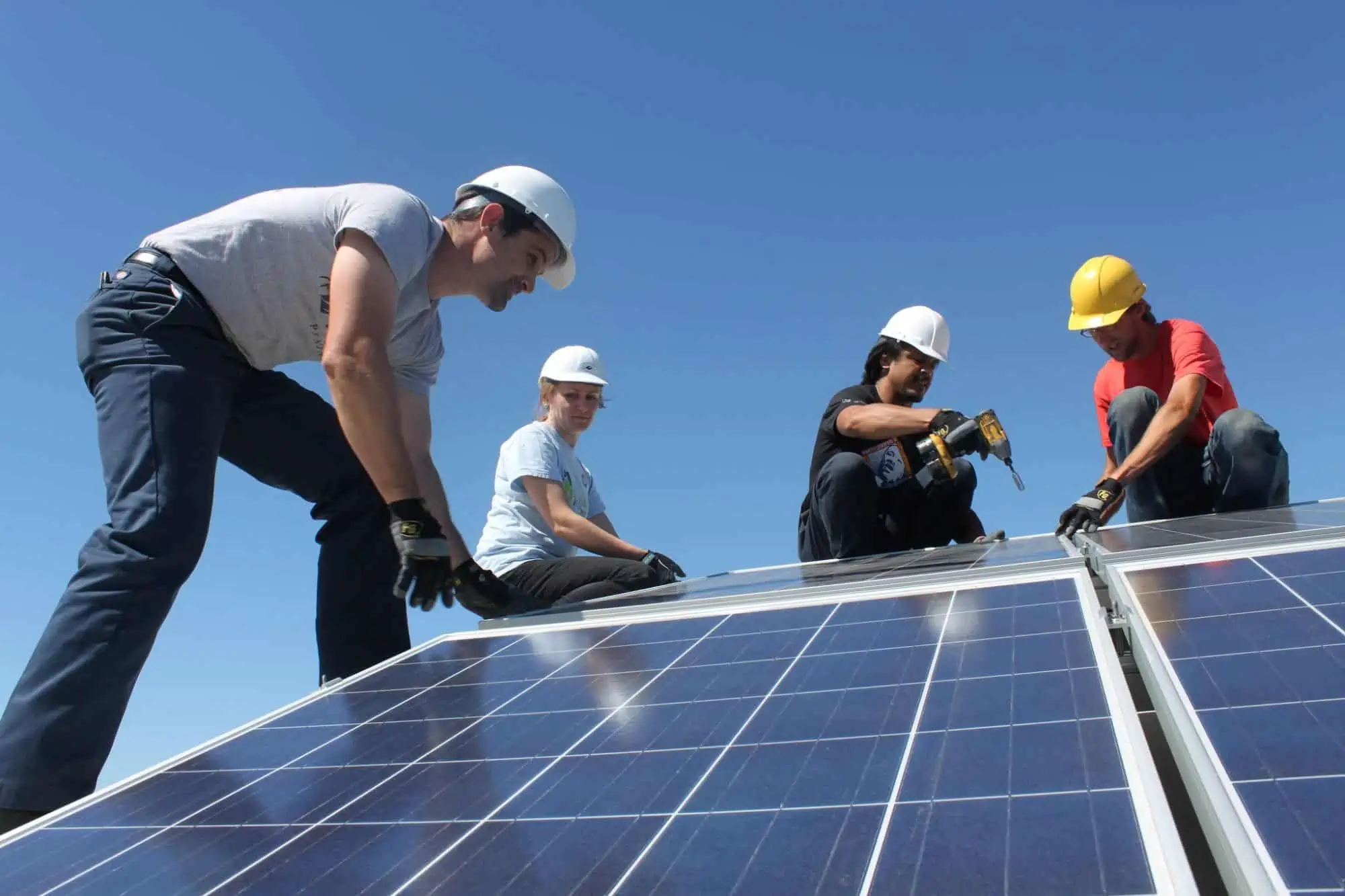 volunteers installing solar panels