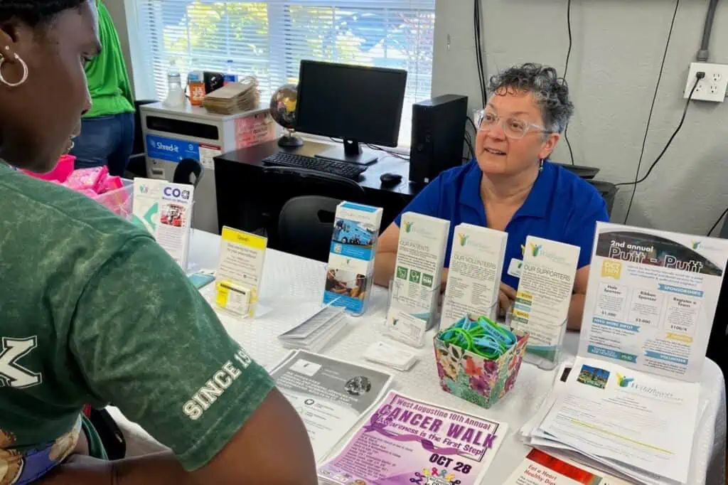 Health Fair client learning about Wildflower Health Care