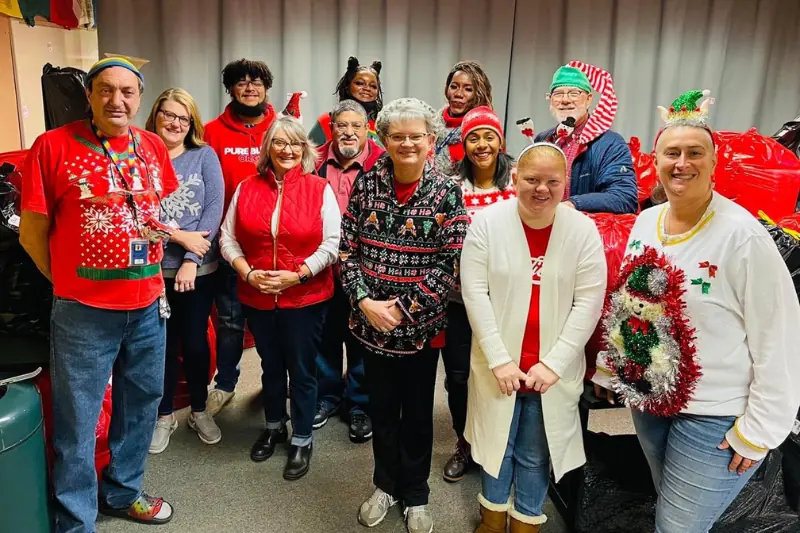 group of people wearing Christmas outfits